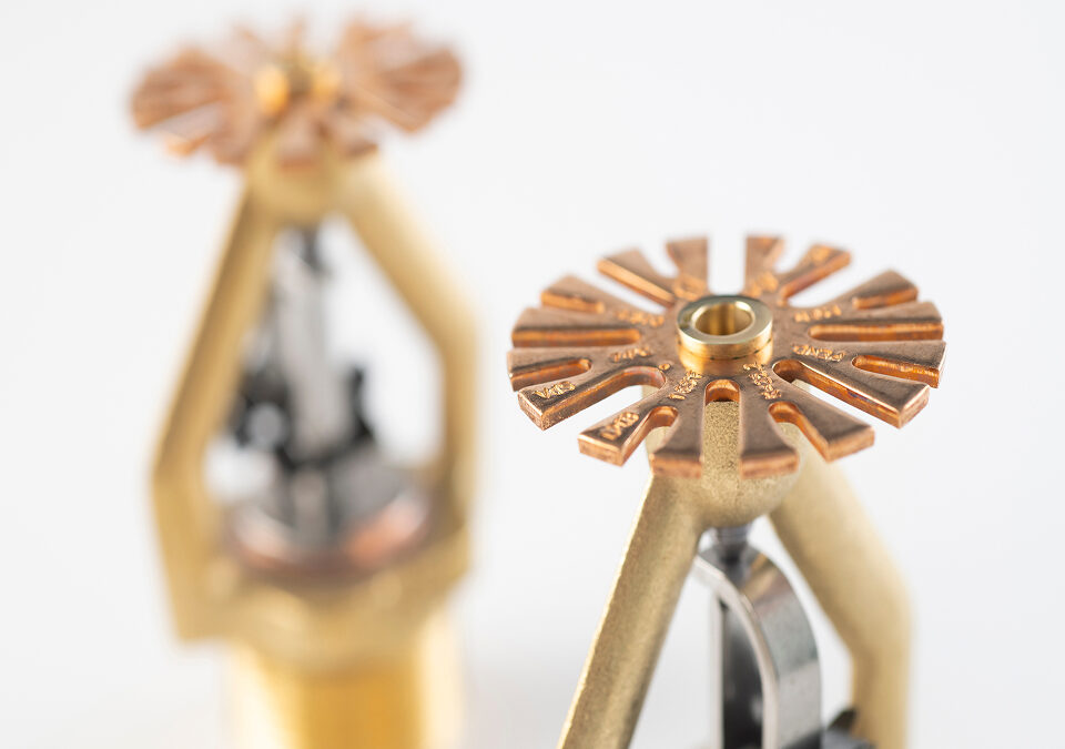 Close-up of brass fire sprinkler heads used in automatic fire protection systems